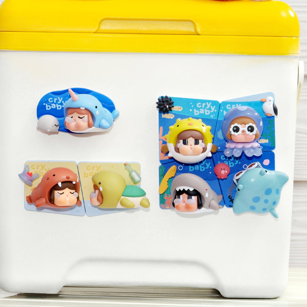 Series magnets displayed on a refrigerator — designs shown are examples