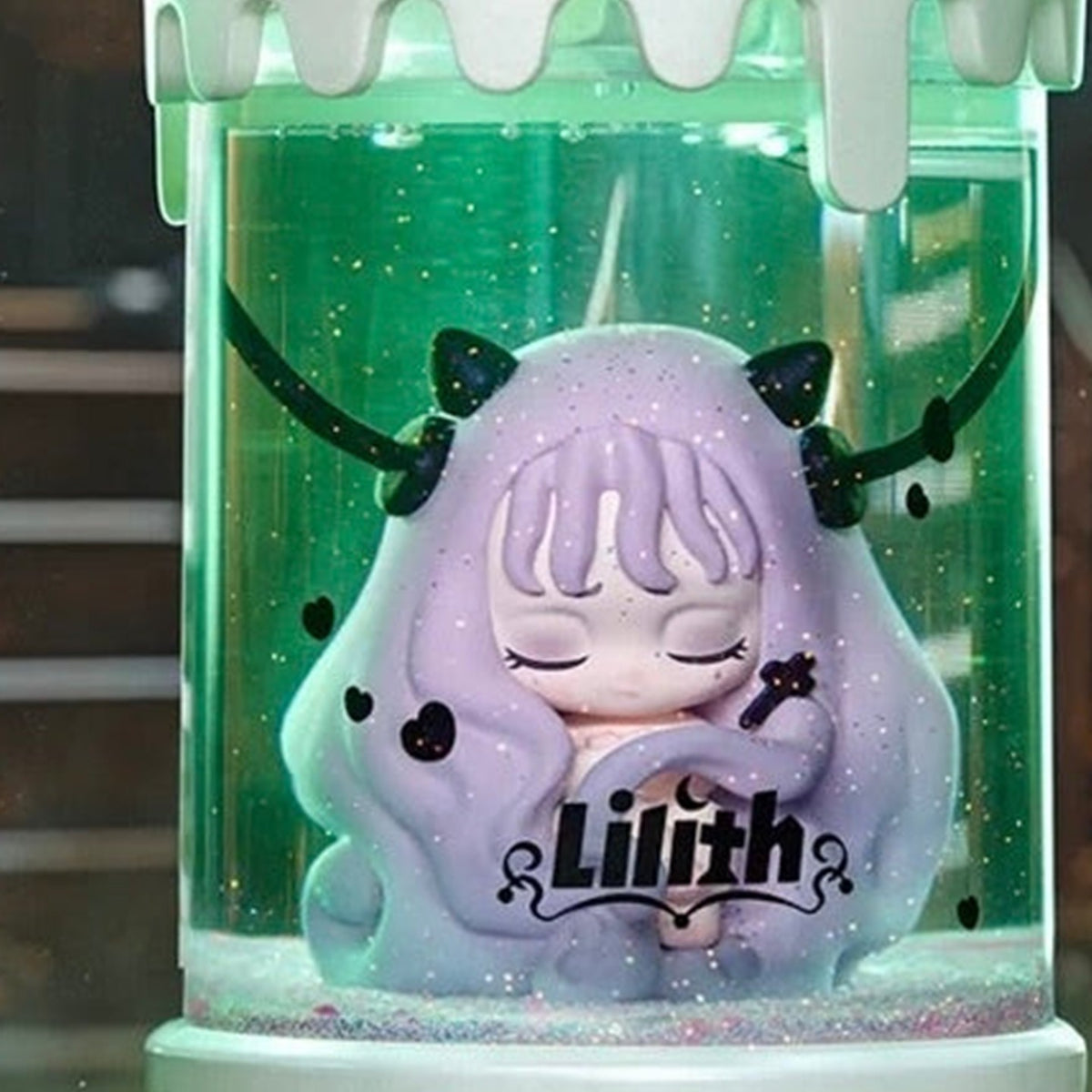 Lilith Secret Experiment purple-haired specimen-jar design detail with original Lilith lettering; secret design shown as a series reference, not guaranteed