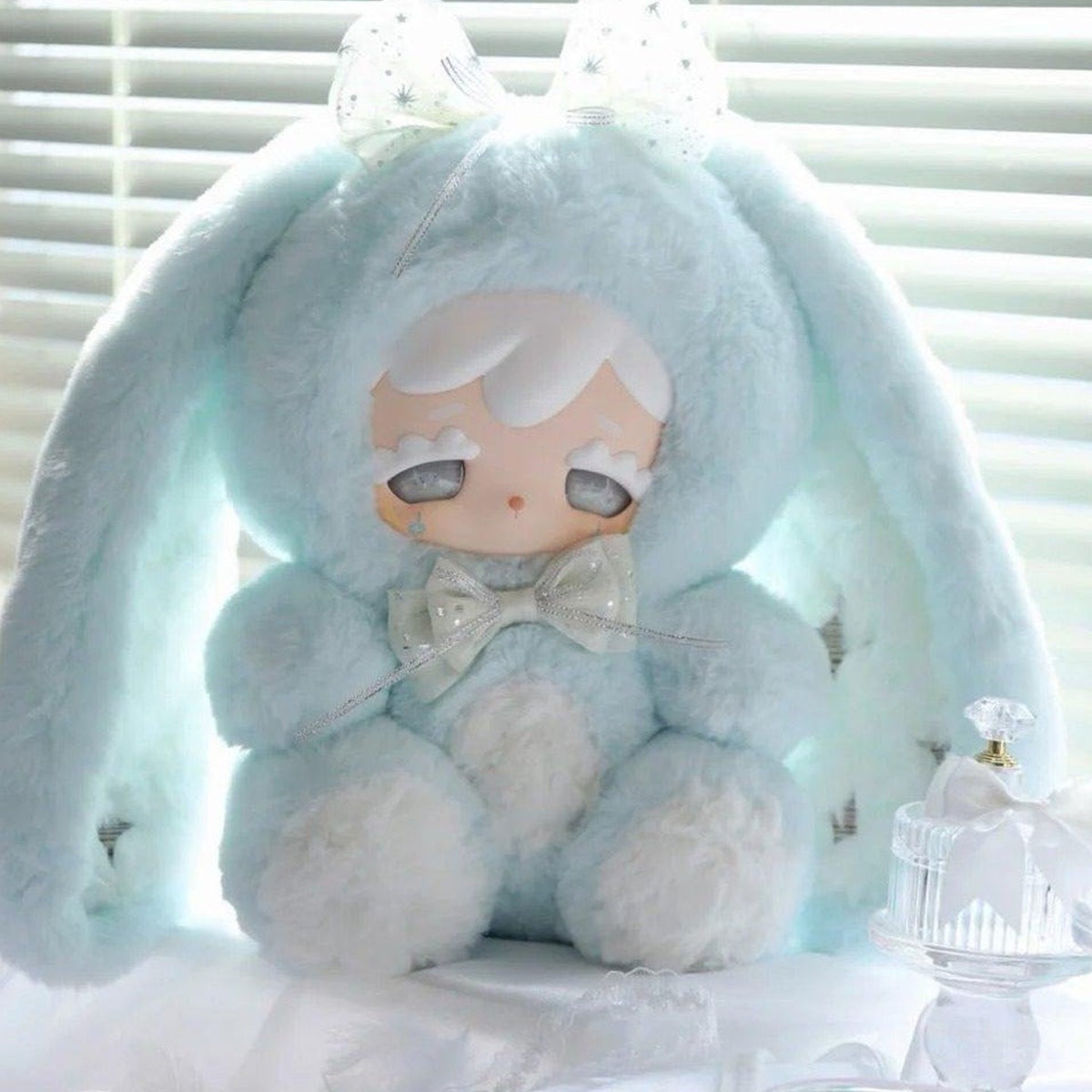 Kokono Lucky Star 600% blue plush doll face, bow and fabric detail; cropped close-up, not a complete-product view