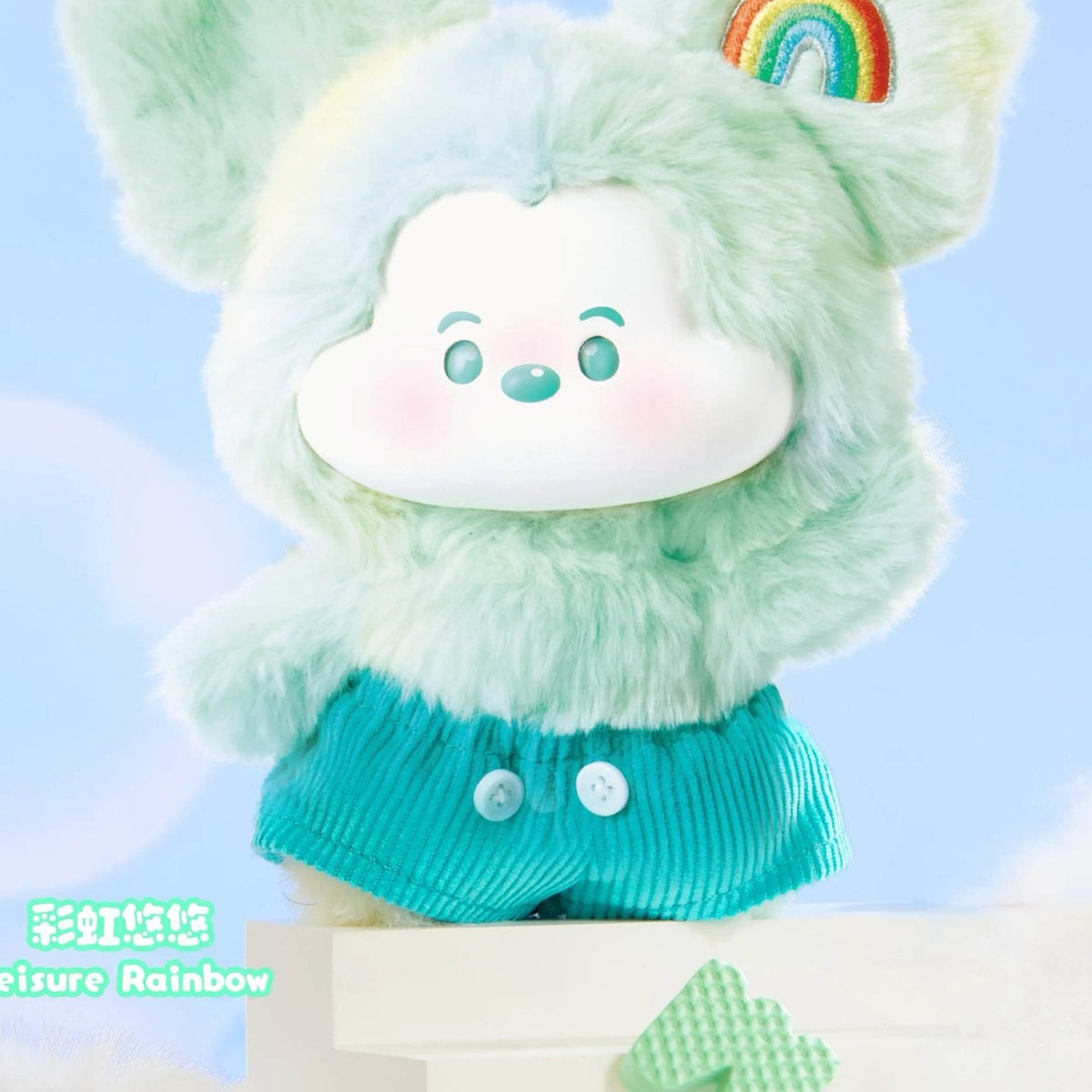 Mickey Head In The Clouds green character with rainbow ear patch and teal shorts detail; cropped illustrative series design