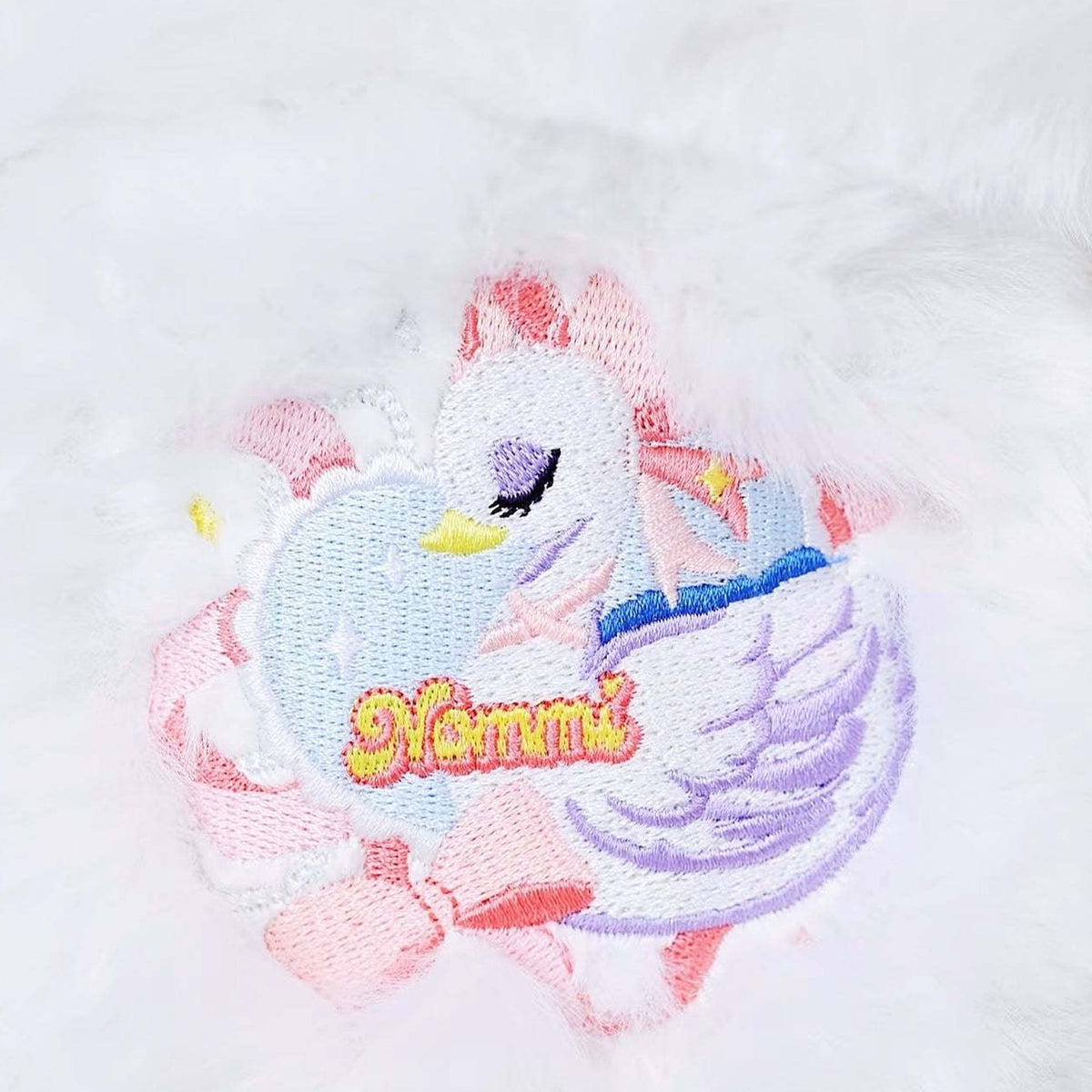 NOMMI Swan Lake original swan and Nommi chest embroidery detail