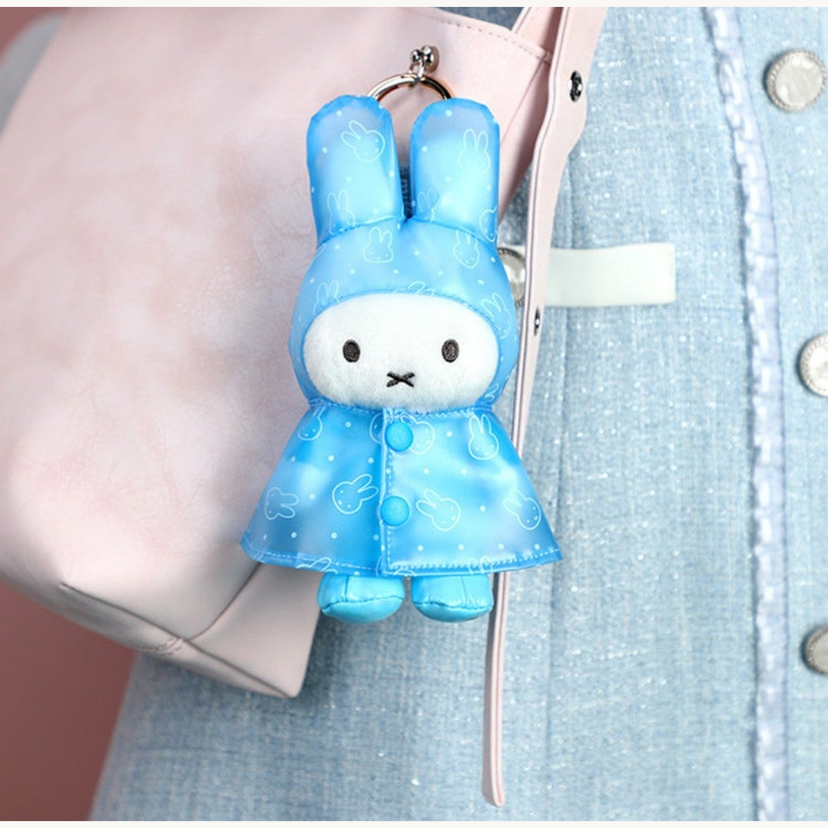 Blue raincoat pendant and visible hanging-ring detail in the original display scene; random design reference