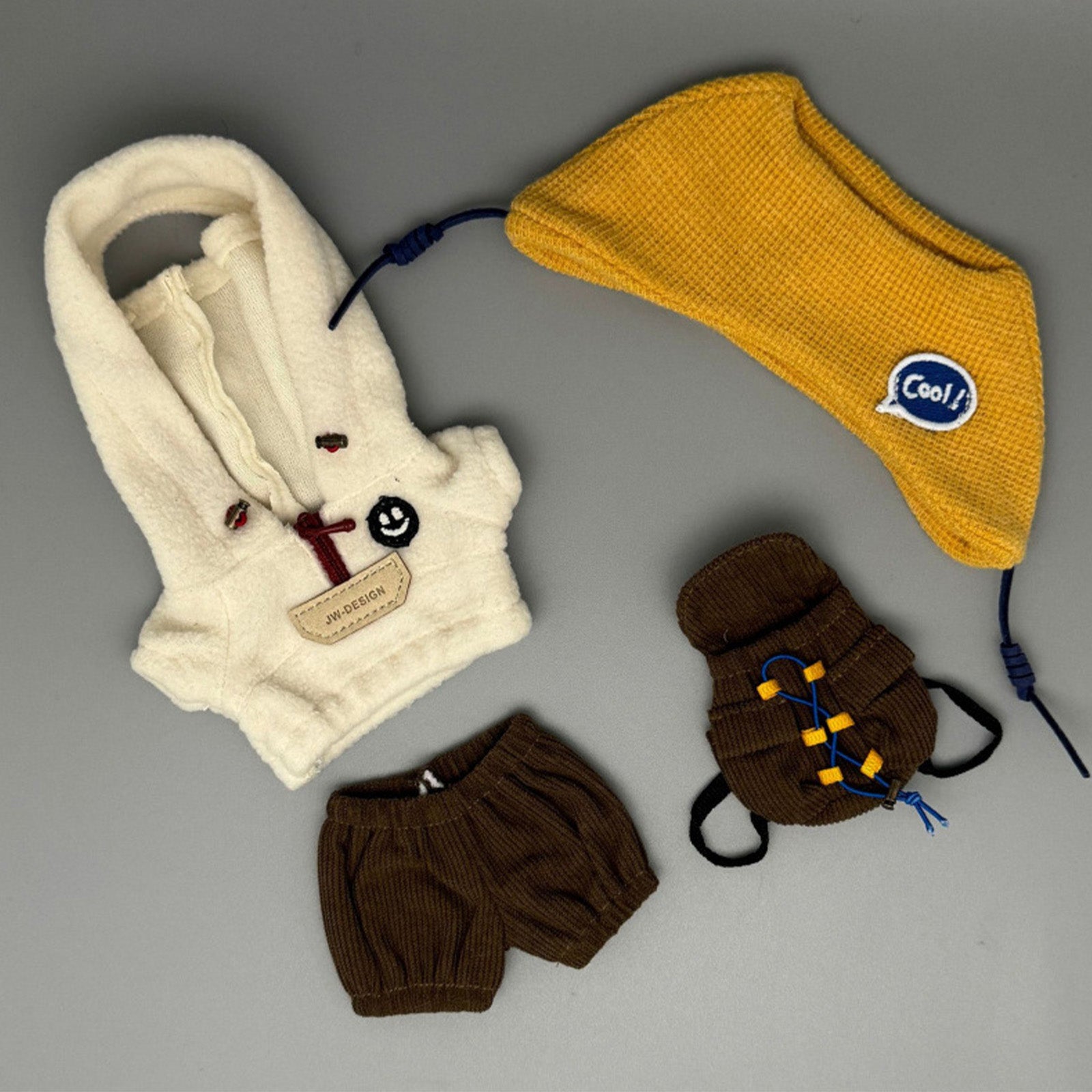 Detailed shot of Labubu 17cm outdoor accessories including a brown corduroy bloomer and a miniature hiking backpack.