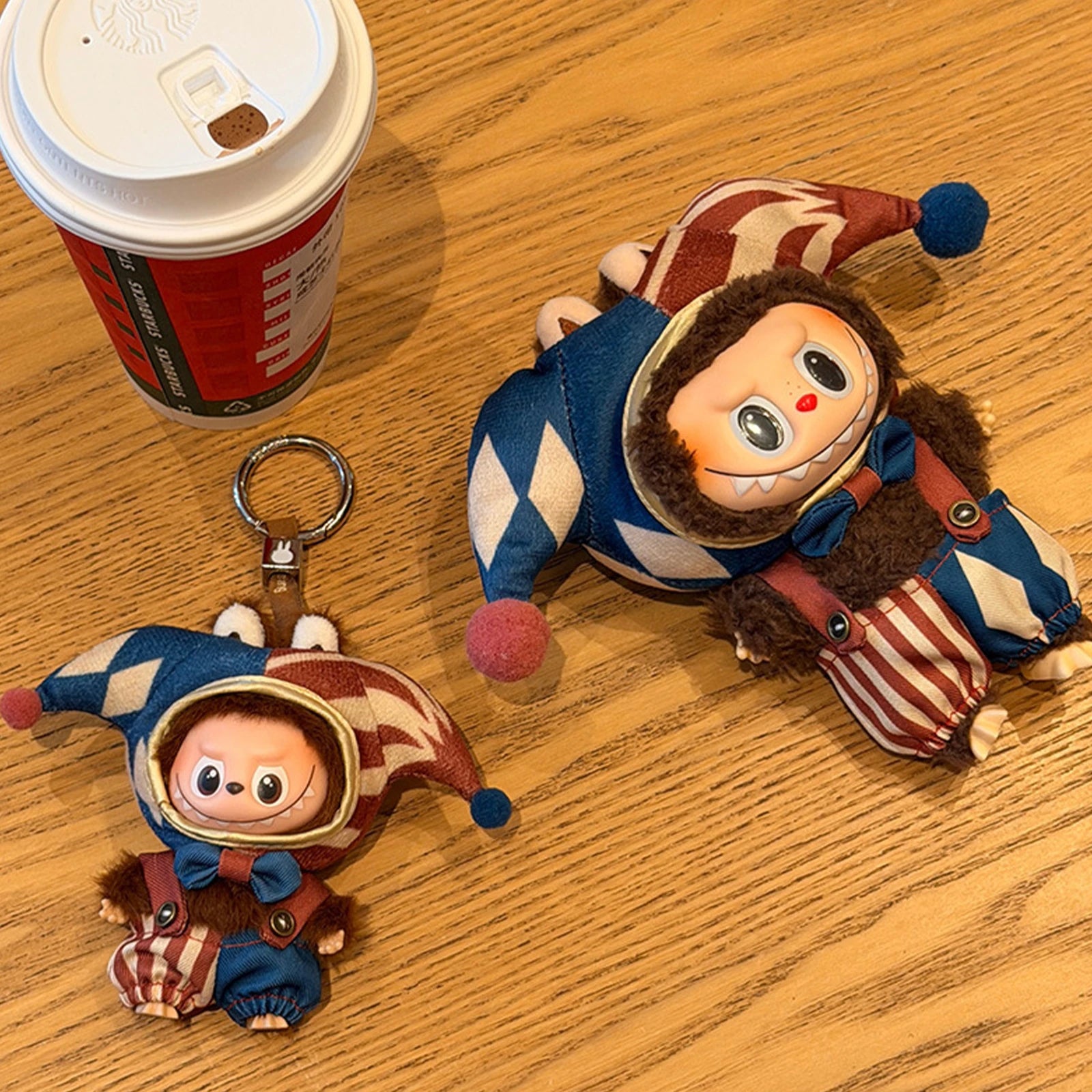 Detailed shot of Labubu 17cm carnival-themed outfit with plush pom-poms and colorful circus design.