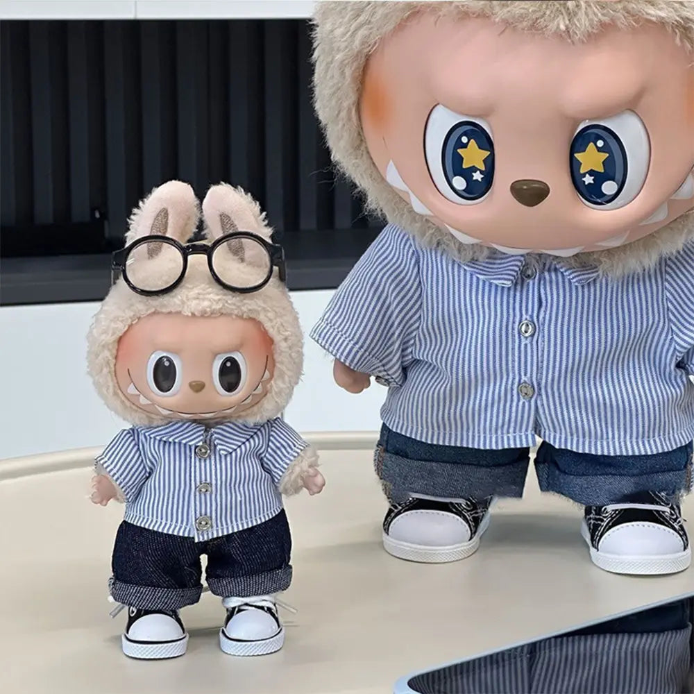 Two labubu dolls wearing matching outfits with glasses and a striped shirt.