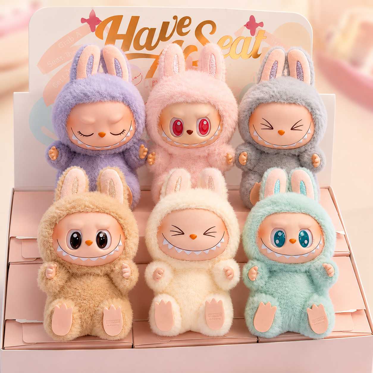 Set of six plush toys in colorful bunny costumes on a pink background with 'Have Seat' text.