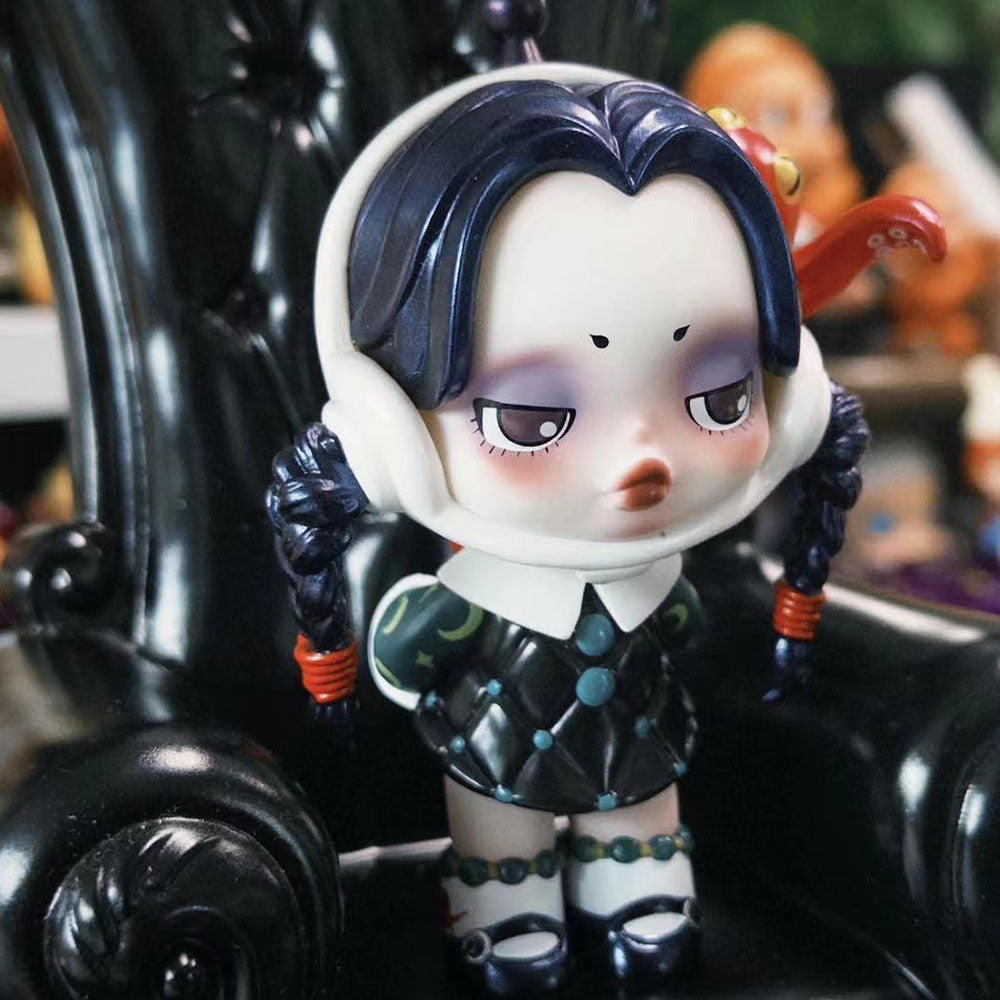 Skullpanda x The Addams Family series blind box figures including Wednesday, Morticia, and Uncle Fester.