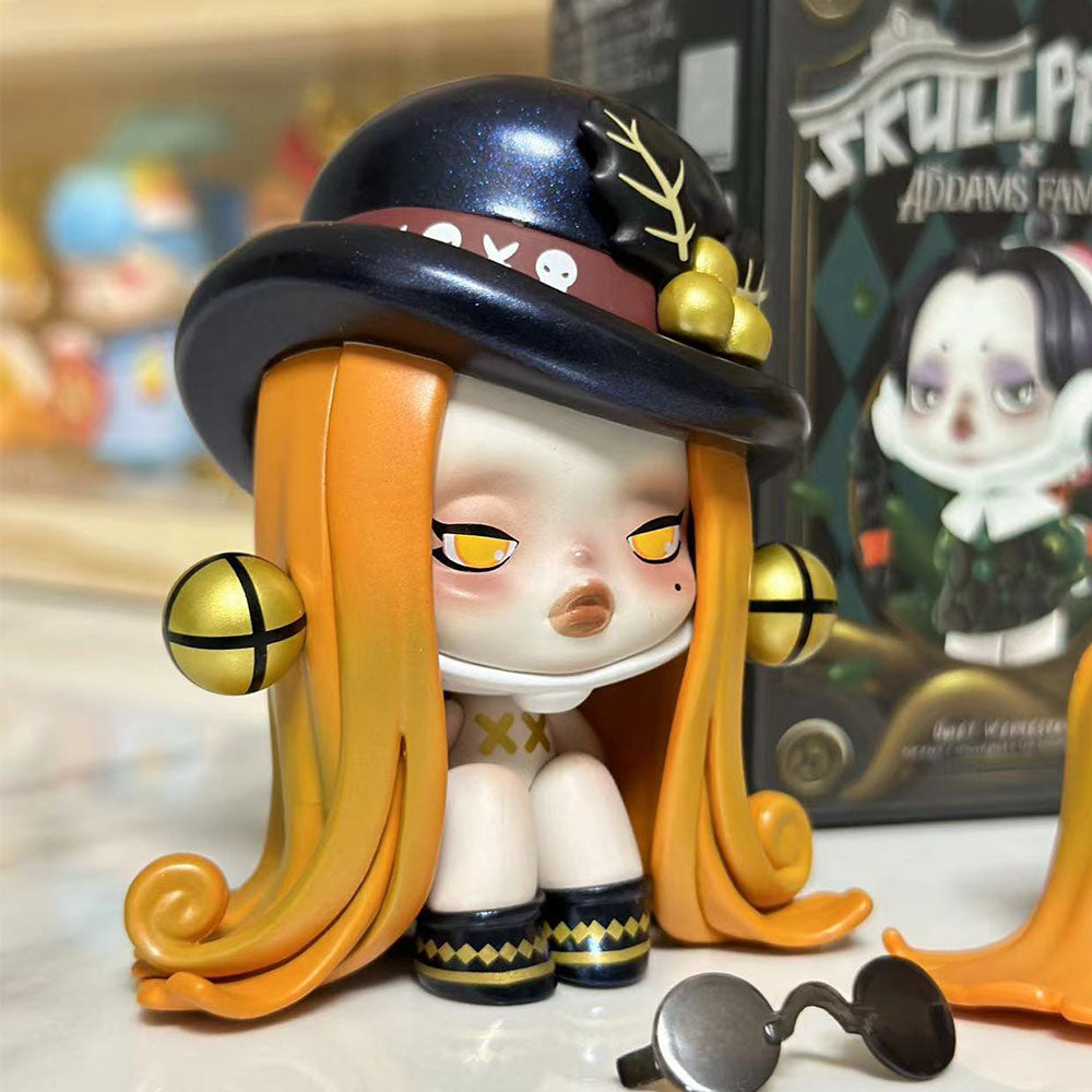 Skullpanda x The Addams Family series blind box figures including Wednesday, Morticia, and Uncle Fester.