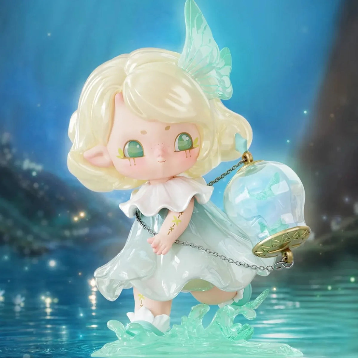Blond-haired figure design example with translucent green wing and lantern-like detail; random design not guaranteed