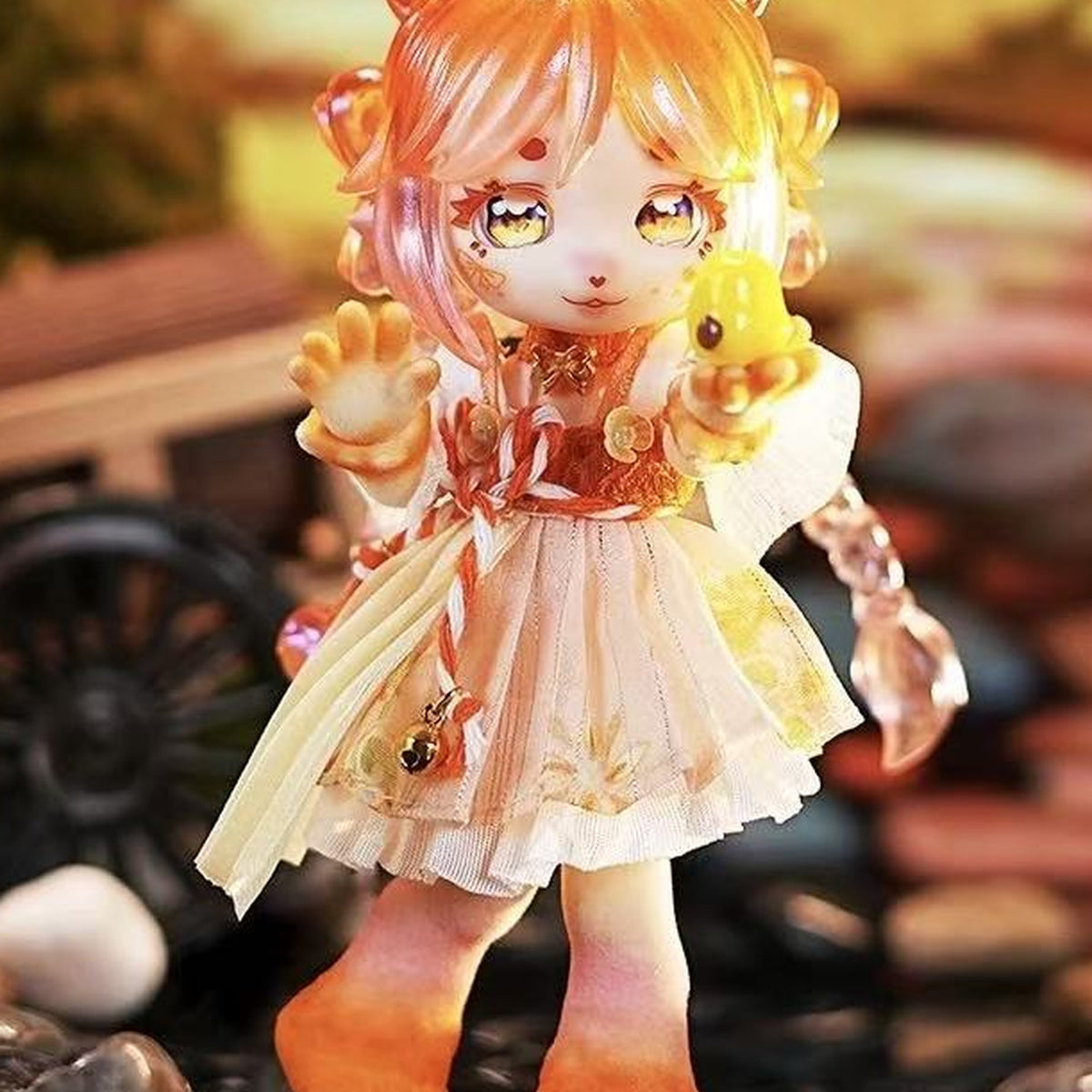 Orange-haired doll in a cream-and-gold outfit holding a yellow bird; exact-series detail reference, random purchase does not guarantee this character