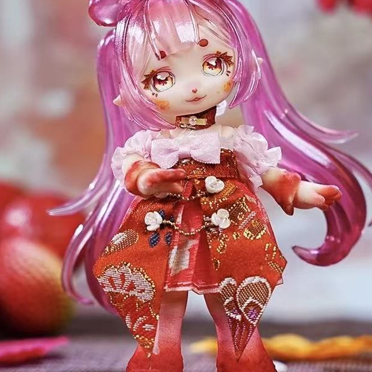 Pink-haired doll with a red patterned outfit; exact-series detail reference, random purchase does not guarantee this character