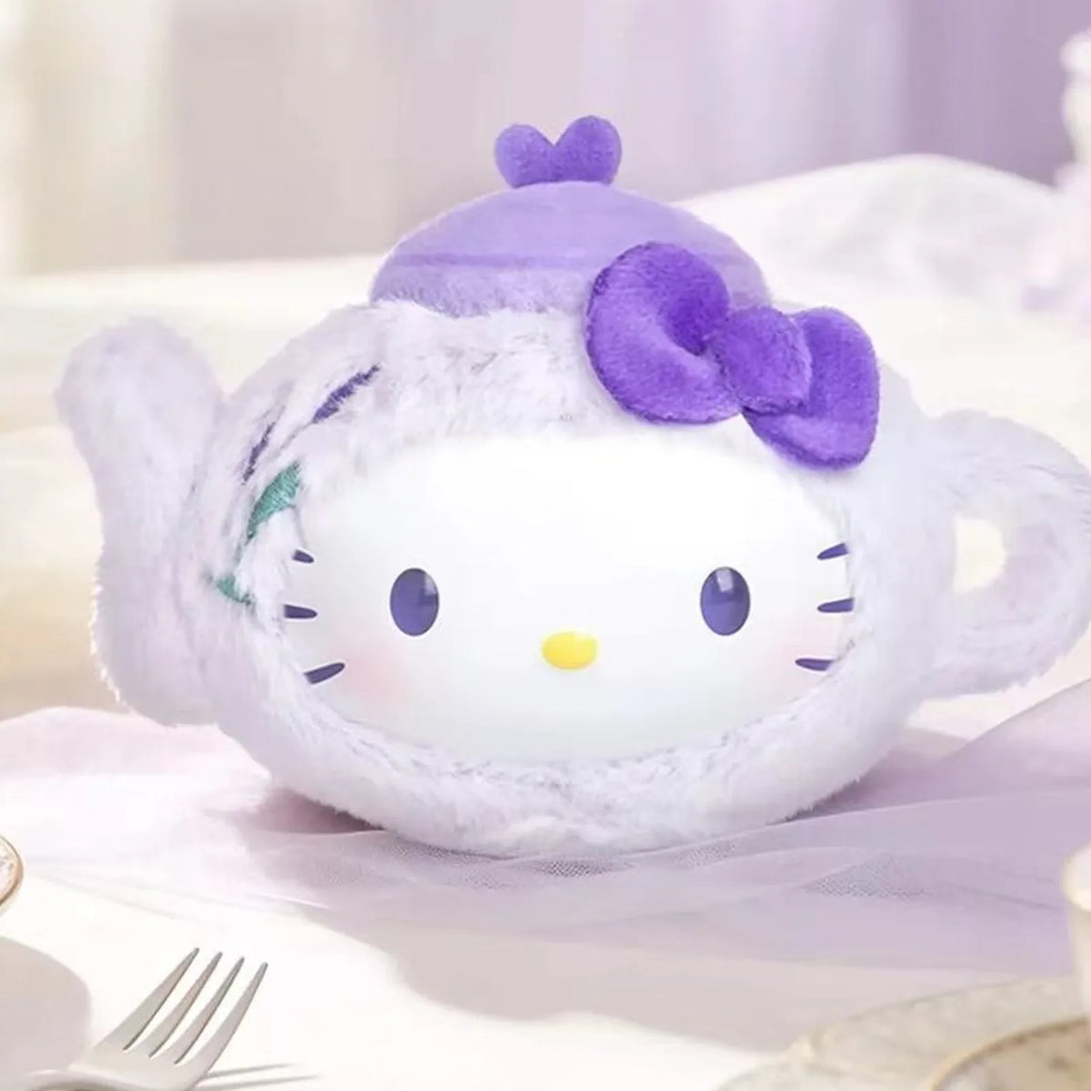 Purple teapot-shaped plush design example with a bow; design not selectable from this photograph