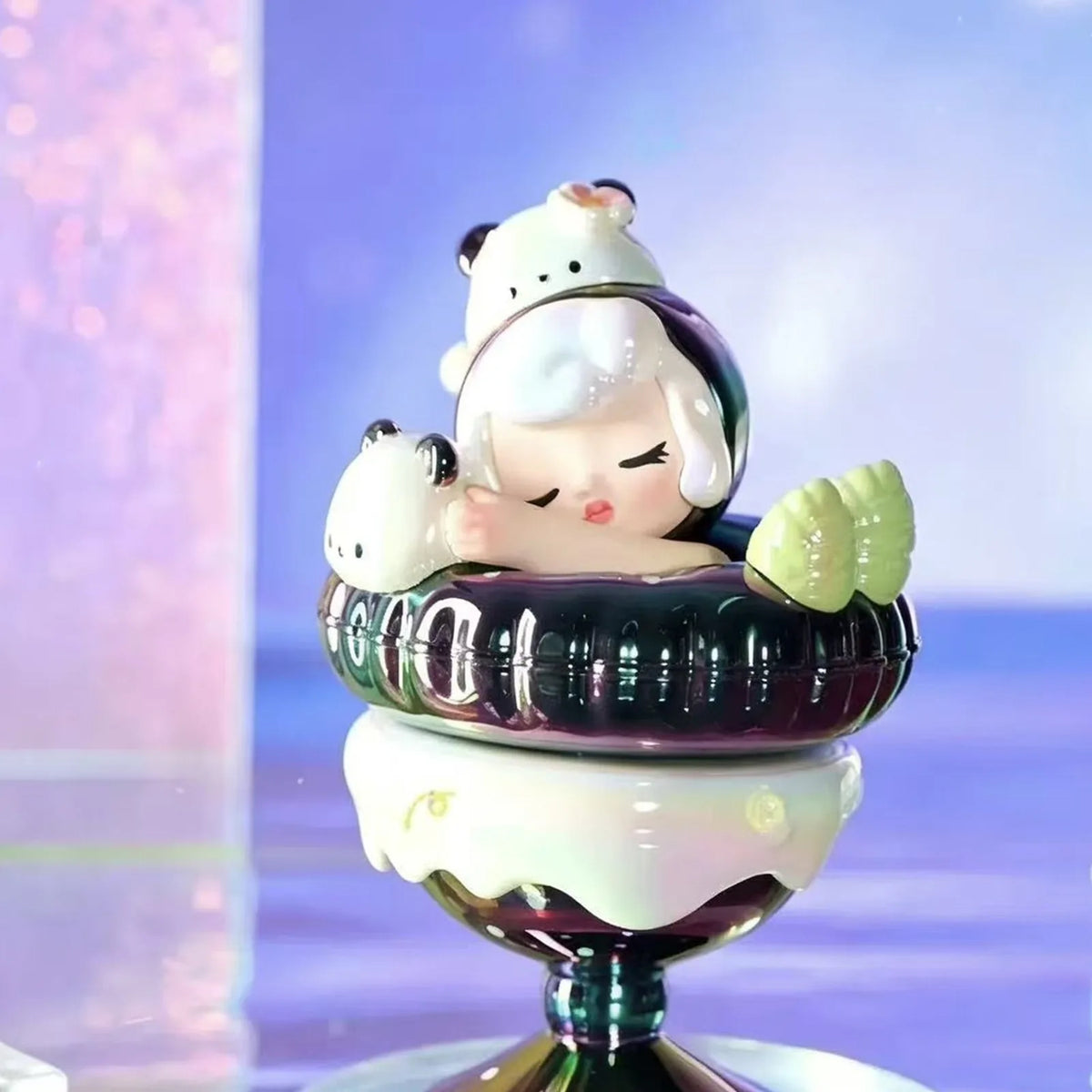 Dark dessert-themed figure example with a small character accessory; design shown is illustrative
