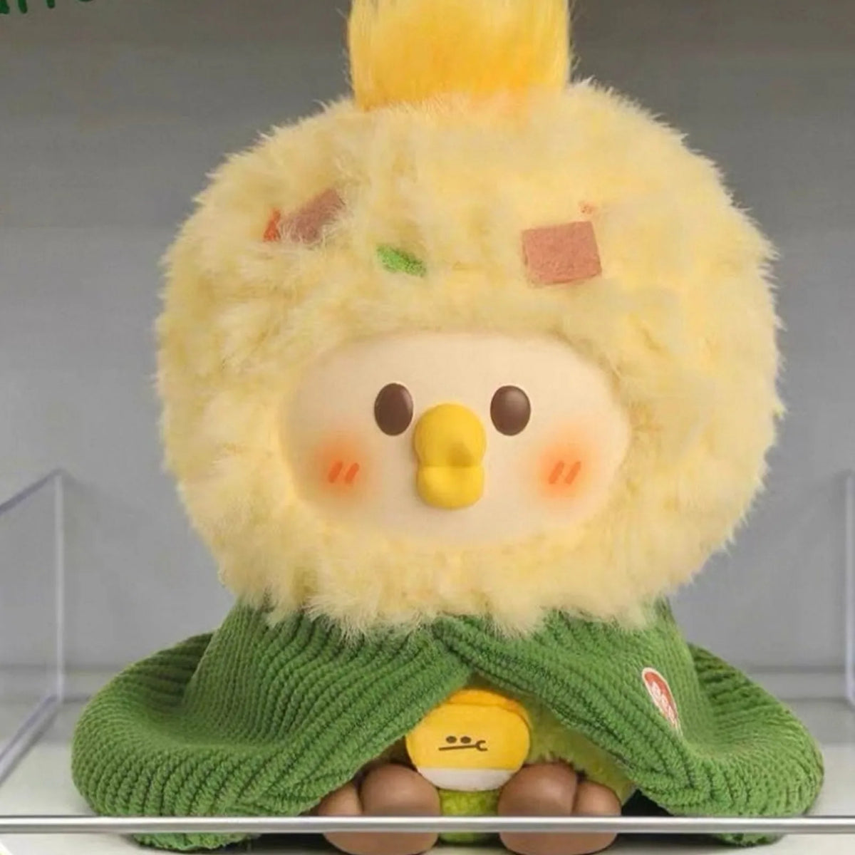 Little Parrot BEBE Foodie Club yellow costume plush face and green clothing detail; series example