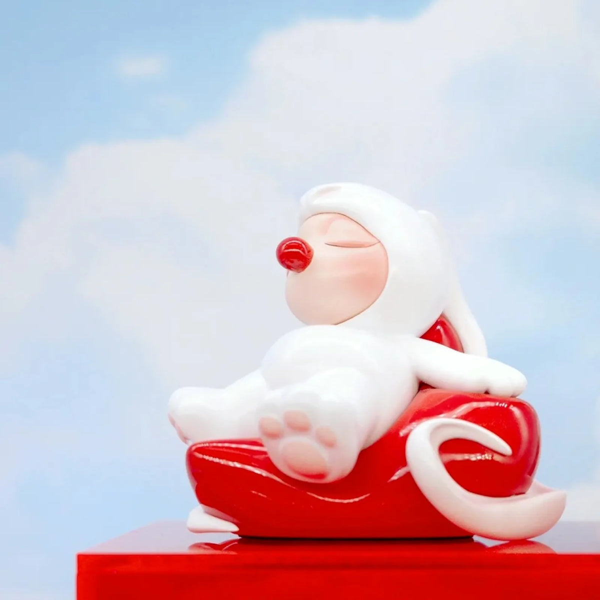 HuiWei Yes! Me Too white figure reclining on a curved red form, showing the complete design as a random-box example.