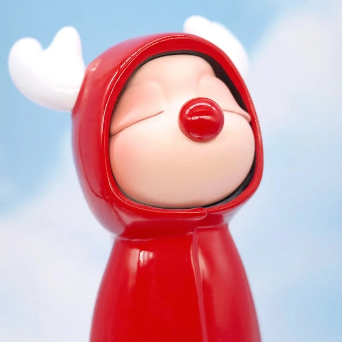 HuiWei Yes! Me Too close-up of a closed-eye face, red nose and red hood; random design is not guaranteed.