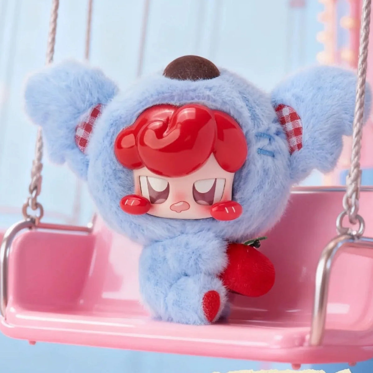 JOKKI's Critter Party complete blue animal-costume design with red hair, seated on a display swing; swing is not a promised inclusion.