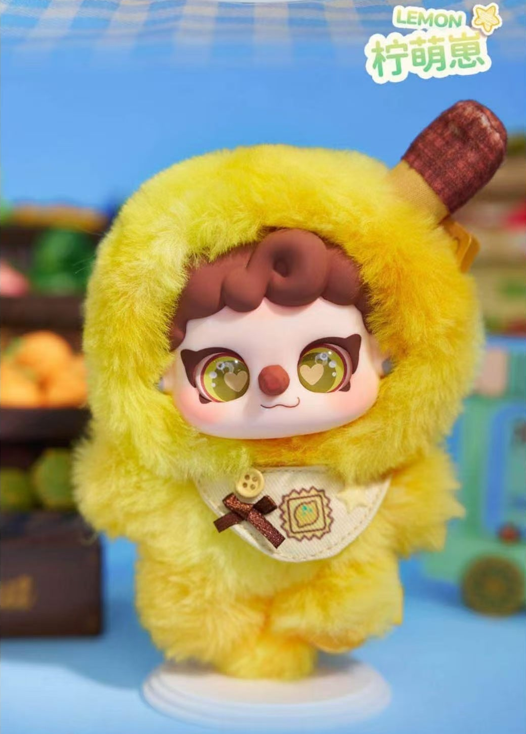 Complete Lemon yellow plush doll design example with full hood, stem decoration, face, bib, hands and feet; original source label retained; random design not guaranteed; random purchases do not guarantee this design