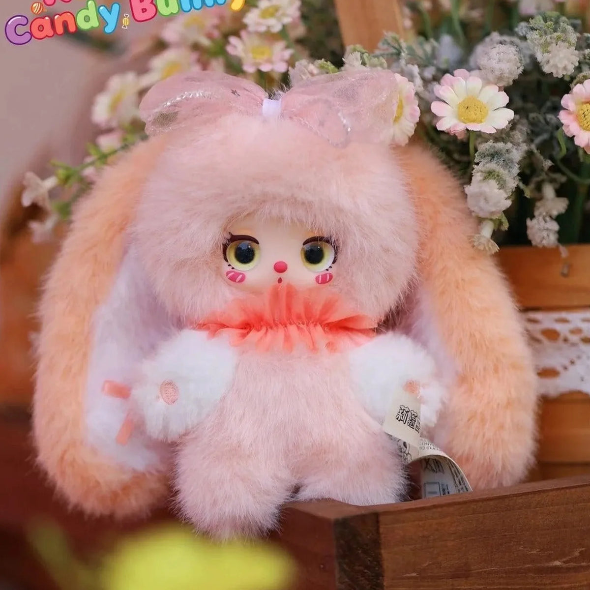 Pink Rainbow Candy Bunny plush among flowers | KikiBuddies