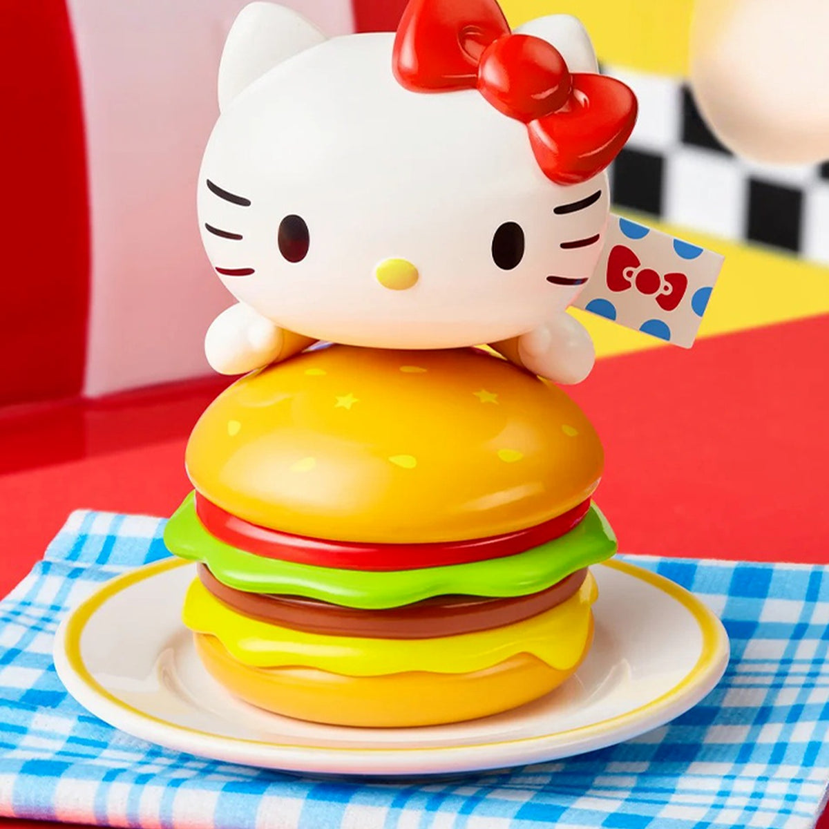 Hello Kitty peeking over a burger in a diner scene; exact series reference, random purchase does not guarantee pictured design