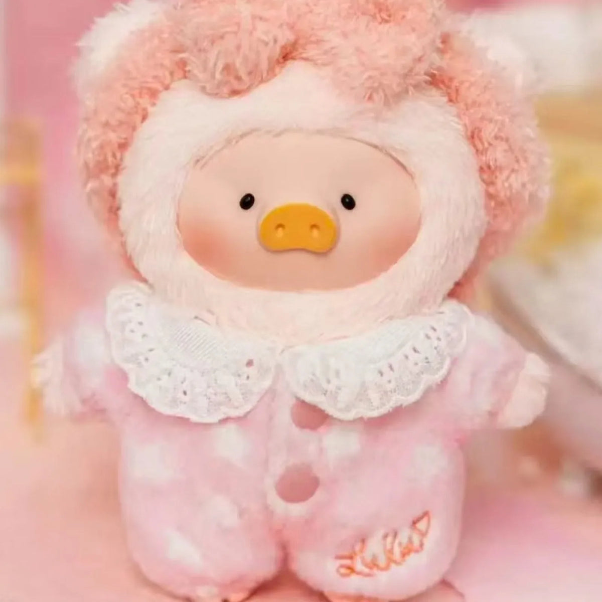 LuLu the Piggy Dreaming Wonderland pink plush design, face and lace-collar detail crop