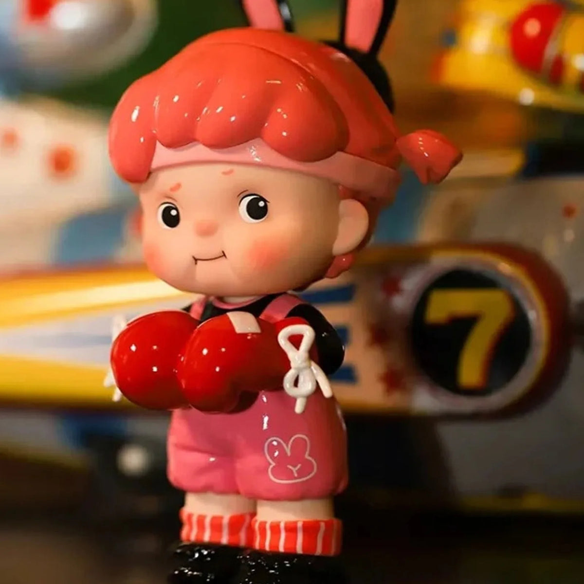 Little Team red-haired figure with a red handheld accessory; series design example | KikiBuddies