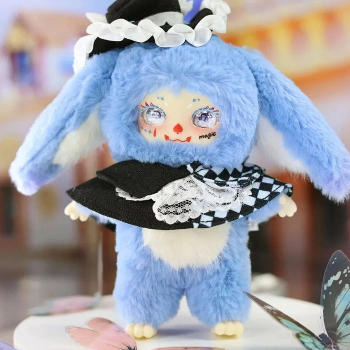 Blue LOKIKI bunny-costume plush in a black-and-white outfit; series design example | KikiBuddies
