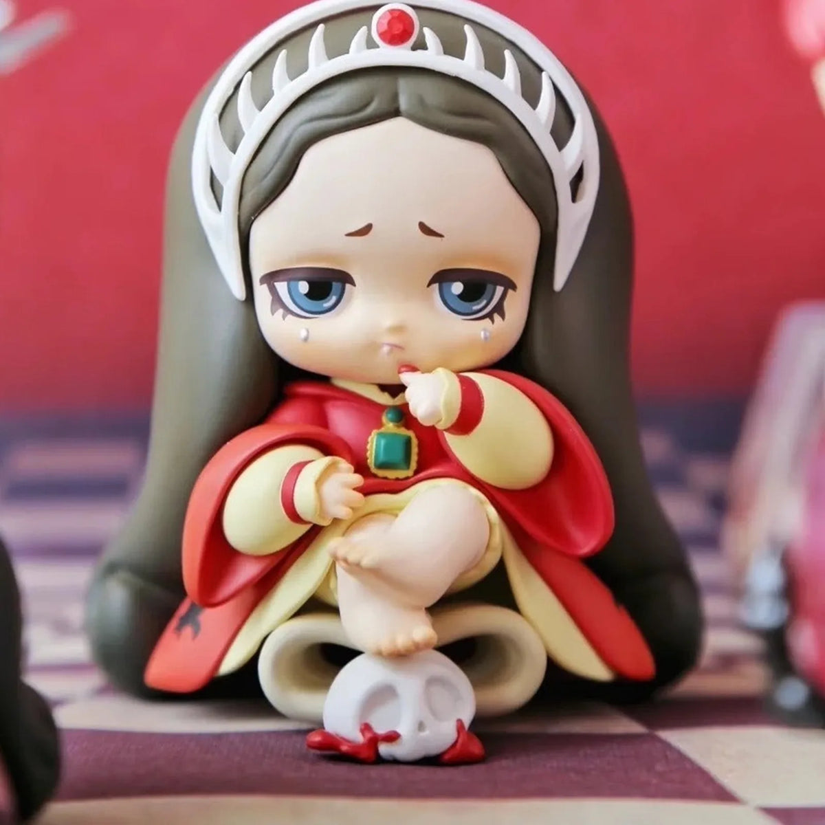 Lilith figure with a crown and red cloak; series design example | KikiBuddies