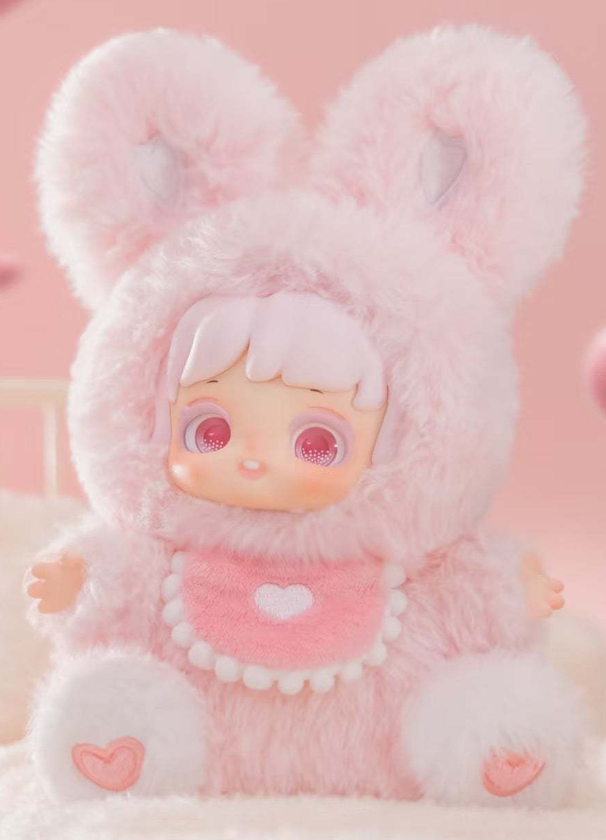 Complete pink Miana plush example with full round ears, face, hands, heart bib, body and both heart-patterned feet; random purchases do not guarantee this design