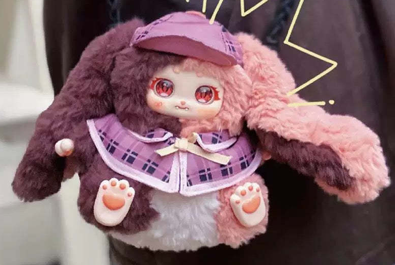Complete Noli Rosemary Town purple and pink plush design example with complete cap, long ears, face, cape, hands and paw pads; random purchases do not guarantee this design