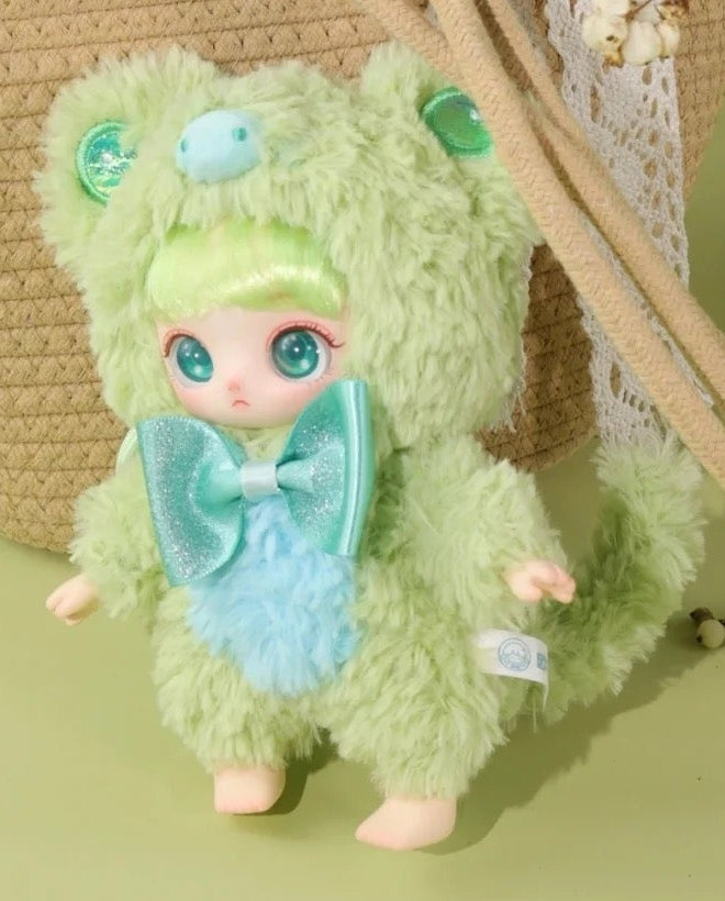 Complete green Miaojiuhua plush example with full hood ears, face, teal bow, hands, blue chest, both feet and curved tail; random purchases do not guarantee this design