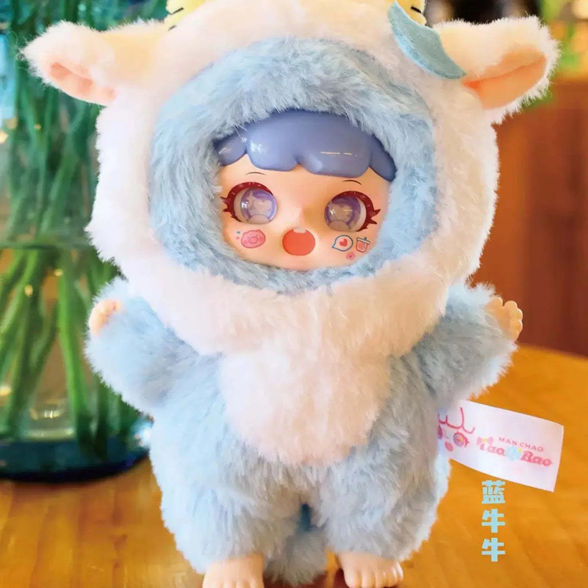 MANCHAO Mischievous Imp Plush Dolls, Blind Box — Blue cow-costume plush example; series example, not guaranteed selection
