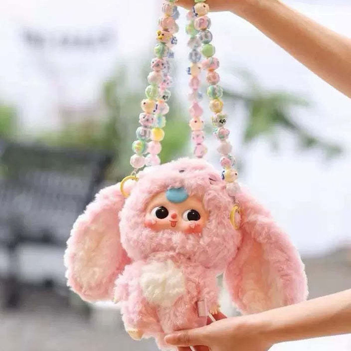 Baby Three V3 pink plush held with decorative beaded chains; chains not included