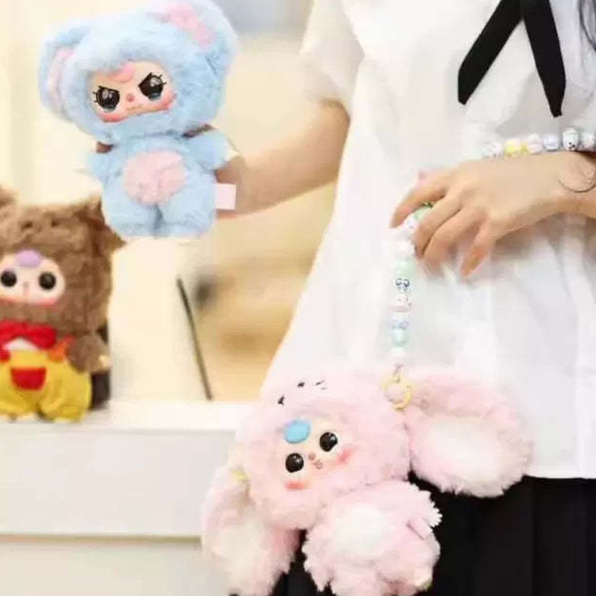 Baby Three V3 plush example designs in a display setting; each blind-box outcome is random