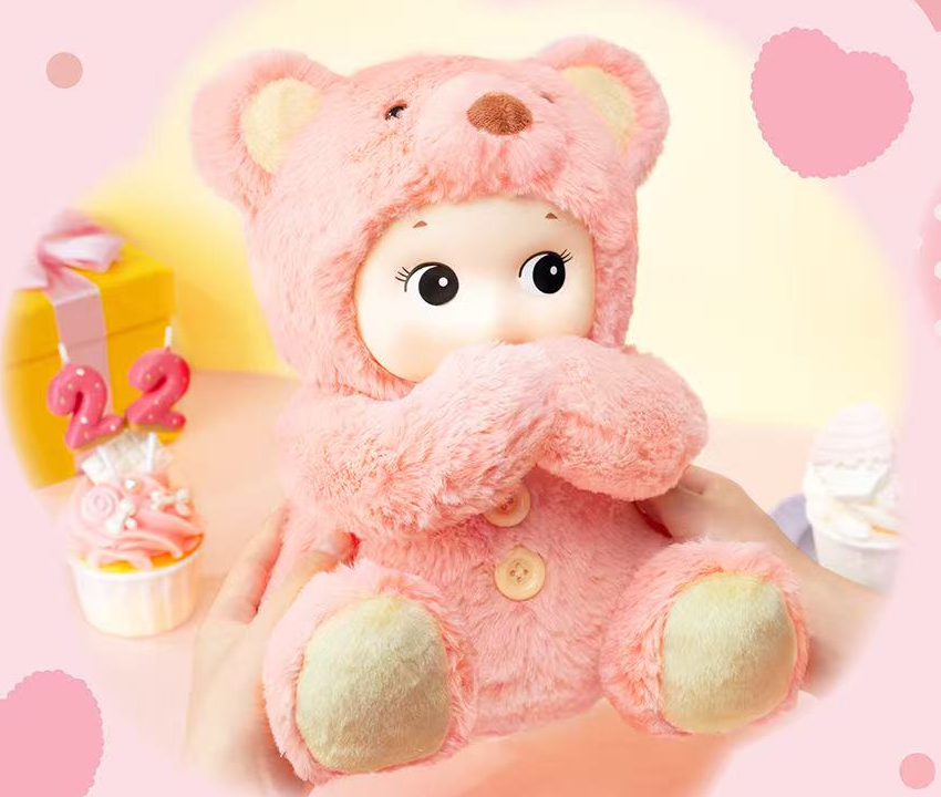 Sonny Angel Cuddly Bear Pink with its movable arms posed together, fixed pink birthday design