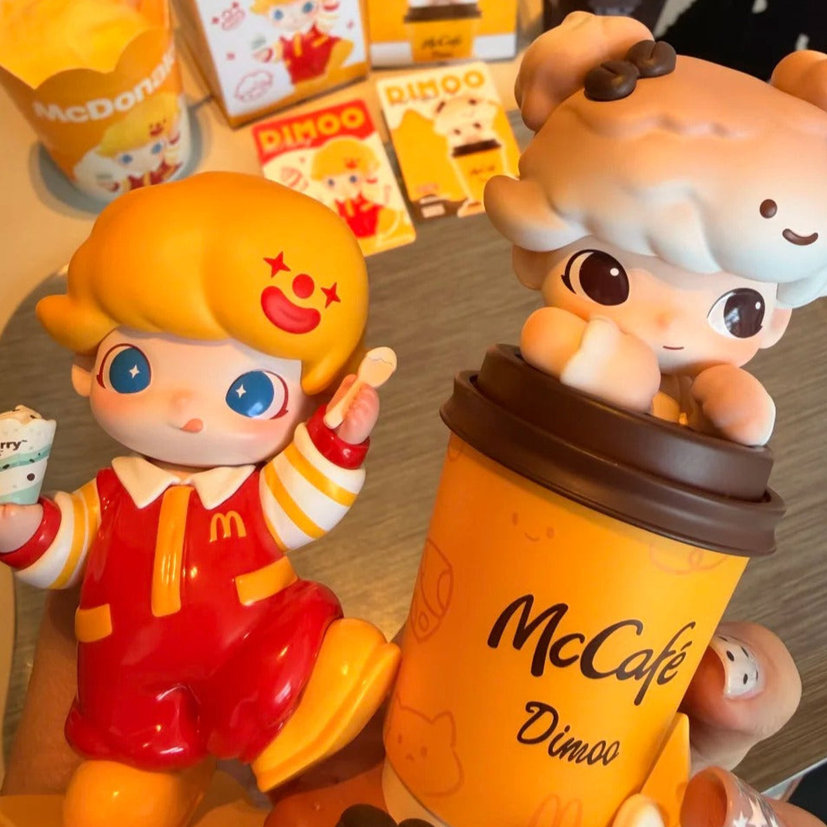 DIMOO McCAFE and McFlurry figures with printed packaging in the background