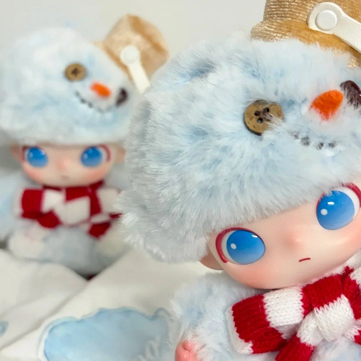 DIMOO Snowman vinyl plush hanging collectible, close view of the snowman hat and face in a display scene; one collectible per order
