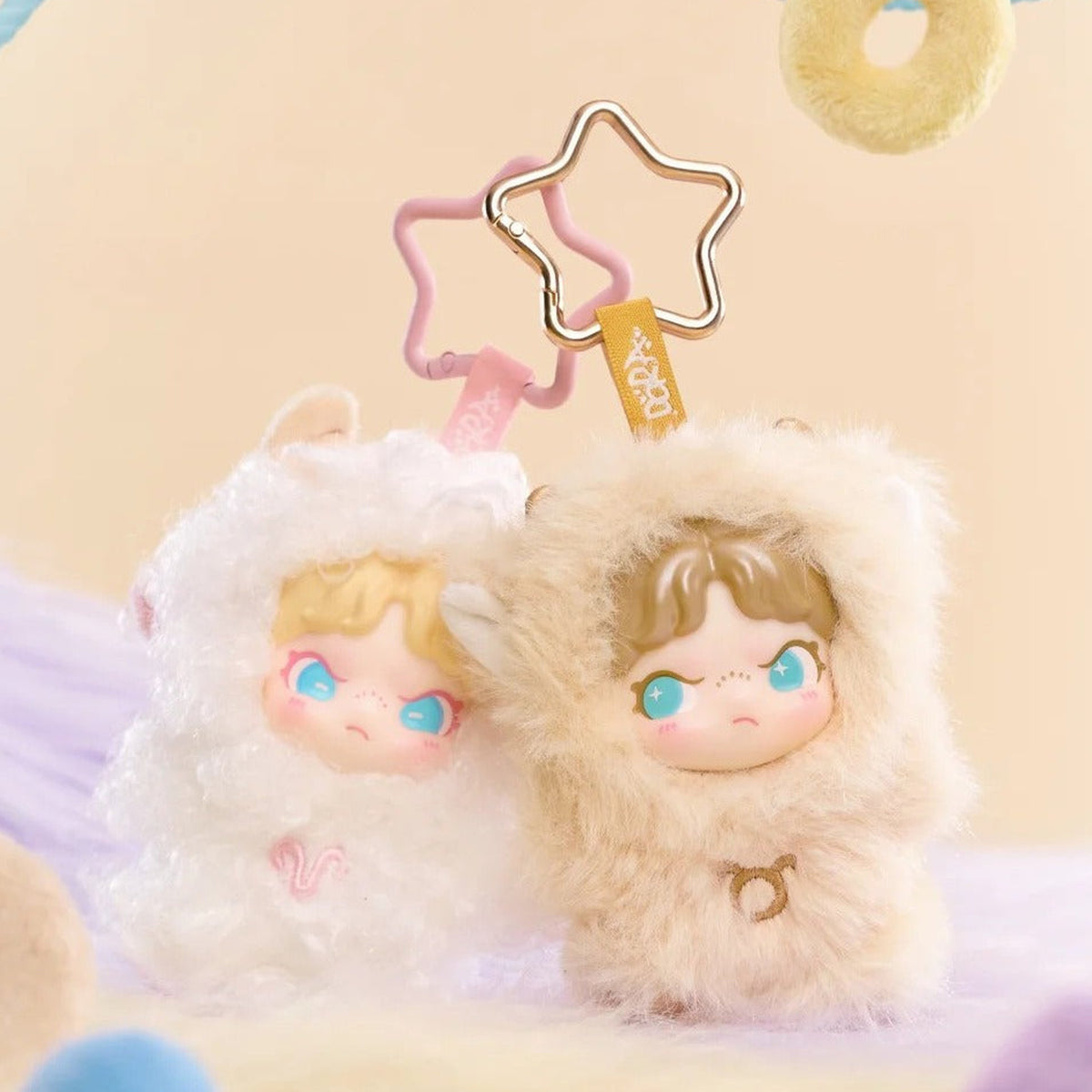 Dora Constellation Monogatari Series Plush Pendant Blind Box - Paired zodiac plush pendant examples with rear star attachment partly obscured; display props not included; random design not guaranteed