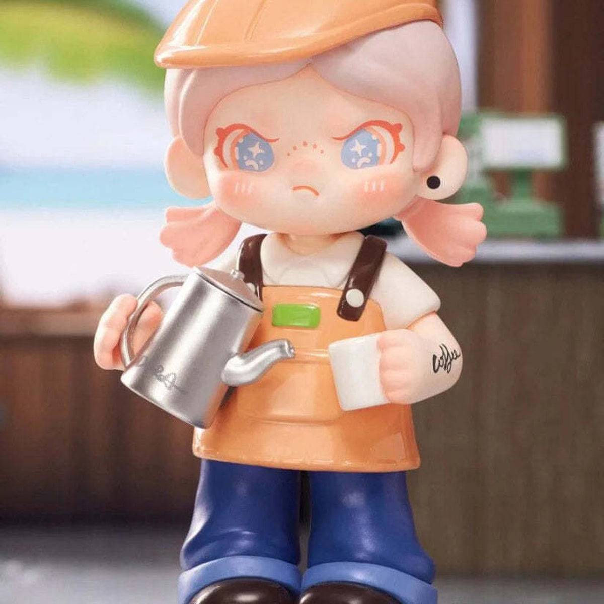 Dora Escape Plan Series Figures, Blind Box - Dora orange-cap design detail with watering-can element; upper cap and lower shoe edges cropped; example design, not guaranteed in random boxes
