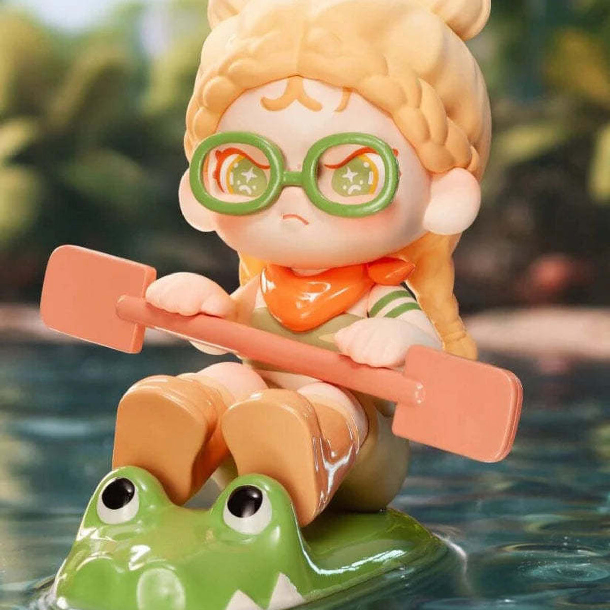Dora Escape Plan Series Figures, Blind Box - Dora rowing design detail with paddle and frog-shaped base; upper hair and lower base edges cropped; example design, not guaranteed in random boxes