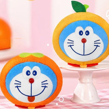 Doraemon Lucky Fruit V1 Series Plush Pendant Blind Box - Complete central orange fruit plush pendant example; right example cropped; display props not included; random design not guaranteed