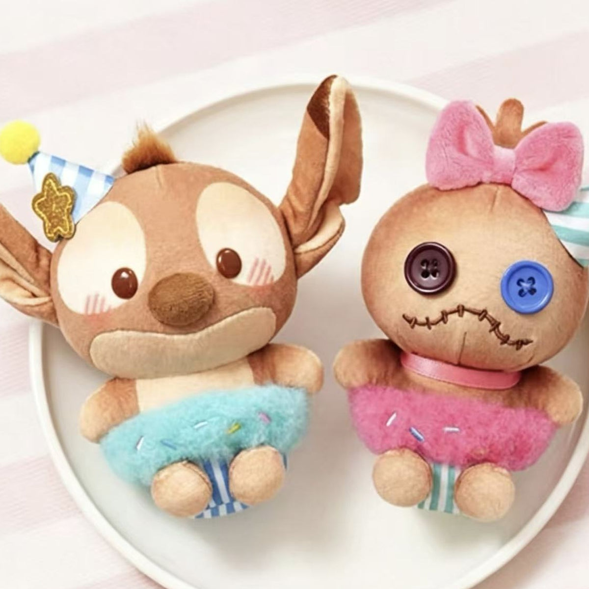 DSN Cocoa Workshop Series Plush Pendant - Complete pink button-face plush pendant example; adjacent blue example cropped; random design not guaranteed