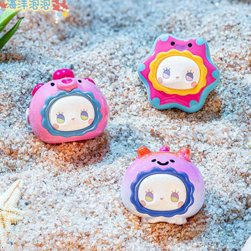 EMMA Ocean Bubble Series Mini Blind Box - Complete ocean-themed mini figure examples on sand; pictured design not guaranteed