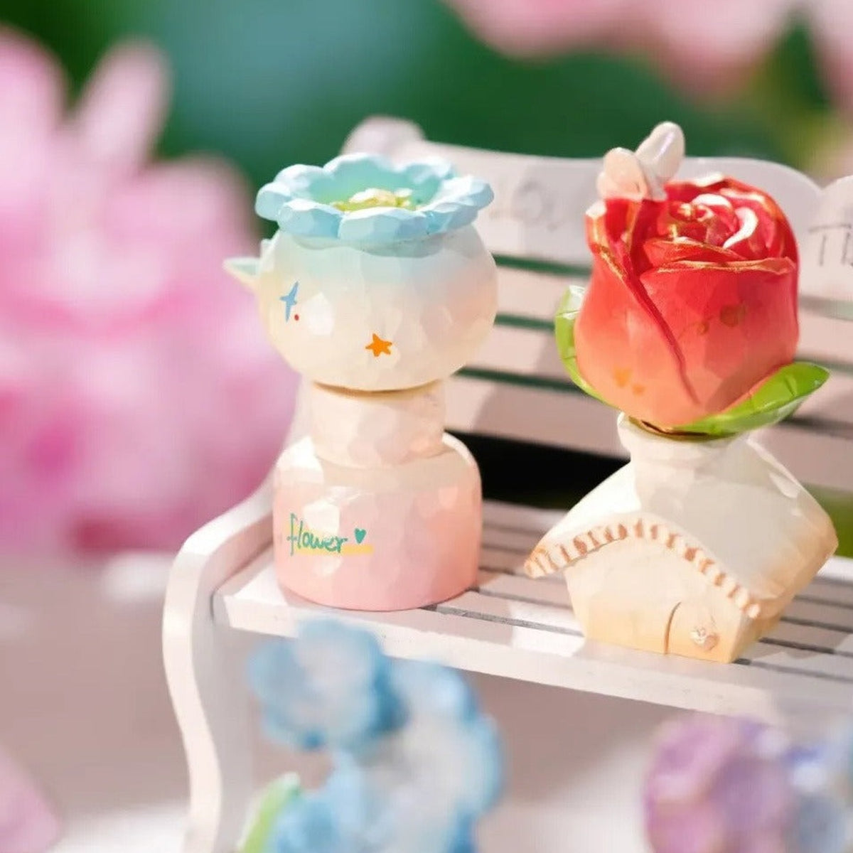 Floral Whispers Series Spin Figure Blind Box - Complete blue flower-shaped spin figure example beside rose example; random design not guaranteed