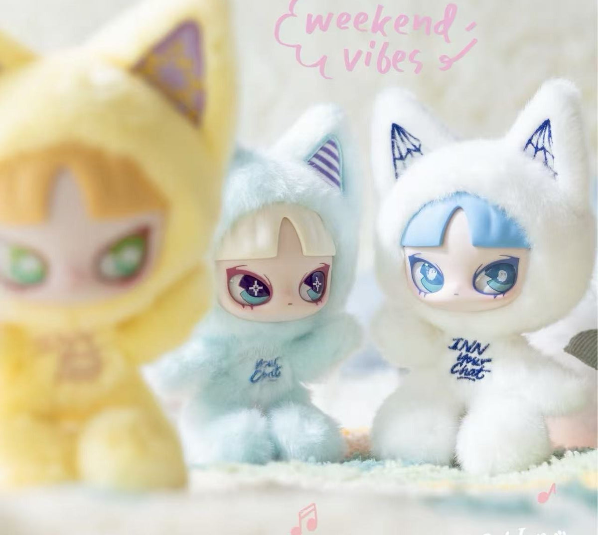 INN Cat Inn Your Chat pale blue and white plush details, with a blurred yellow design in the foreground