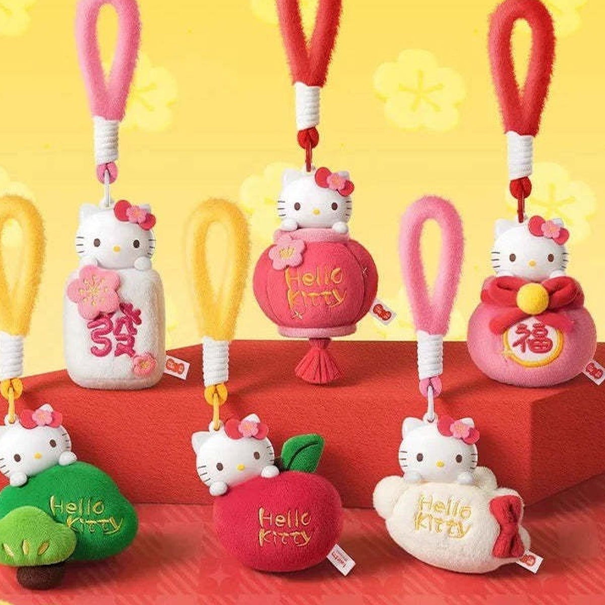 Hello KT New Year Series Plush Pendant Dolls Blind Box - Series overview with complete central Hello Kitty plush pendant examples; outer example and upper straps cropped; display props not included; random design not guaranteed