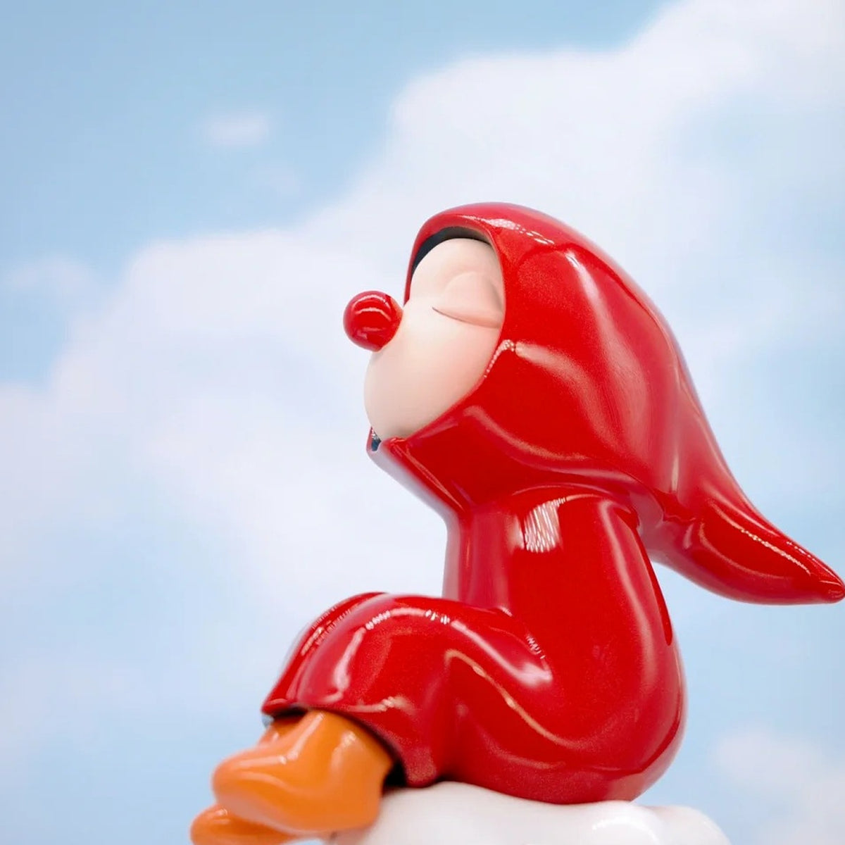 HuiWei Yes! Me Too red-hooded figure in a reclining pose, shown as another design example.