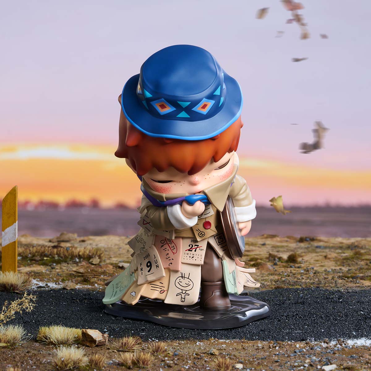 HIRONO x Stefanie Sun Weather With You figurine, front view showing blue patterned hat and calendar-note coat