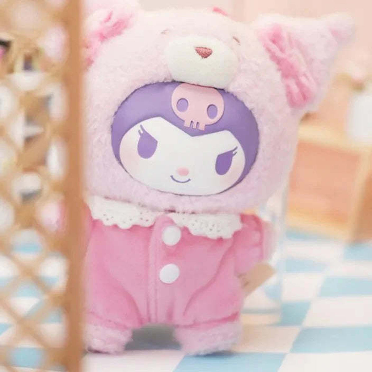 KUROMI Peach Berry plush close front view behind a blurred foreground prop; styling reference