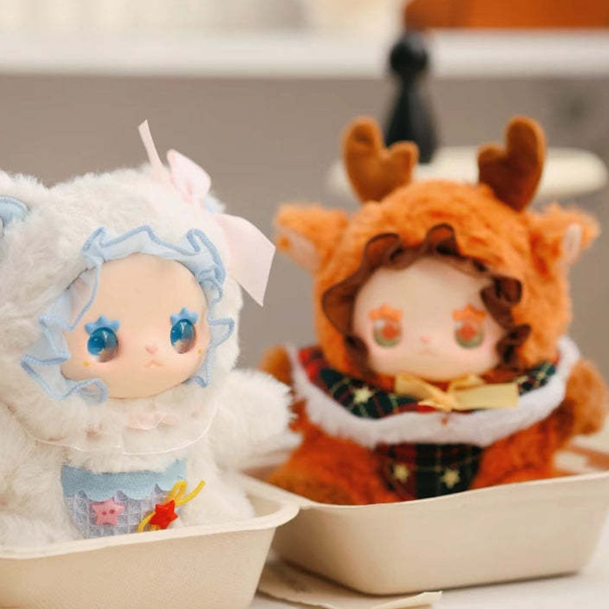Lovely Emma Pocket Zoo white and deer-costume plush dolls in a display; examples